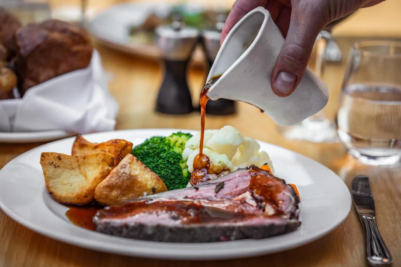Chef finishing a plated dish at Royal Station Hotel restaurant, Newcastle upon Tyne