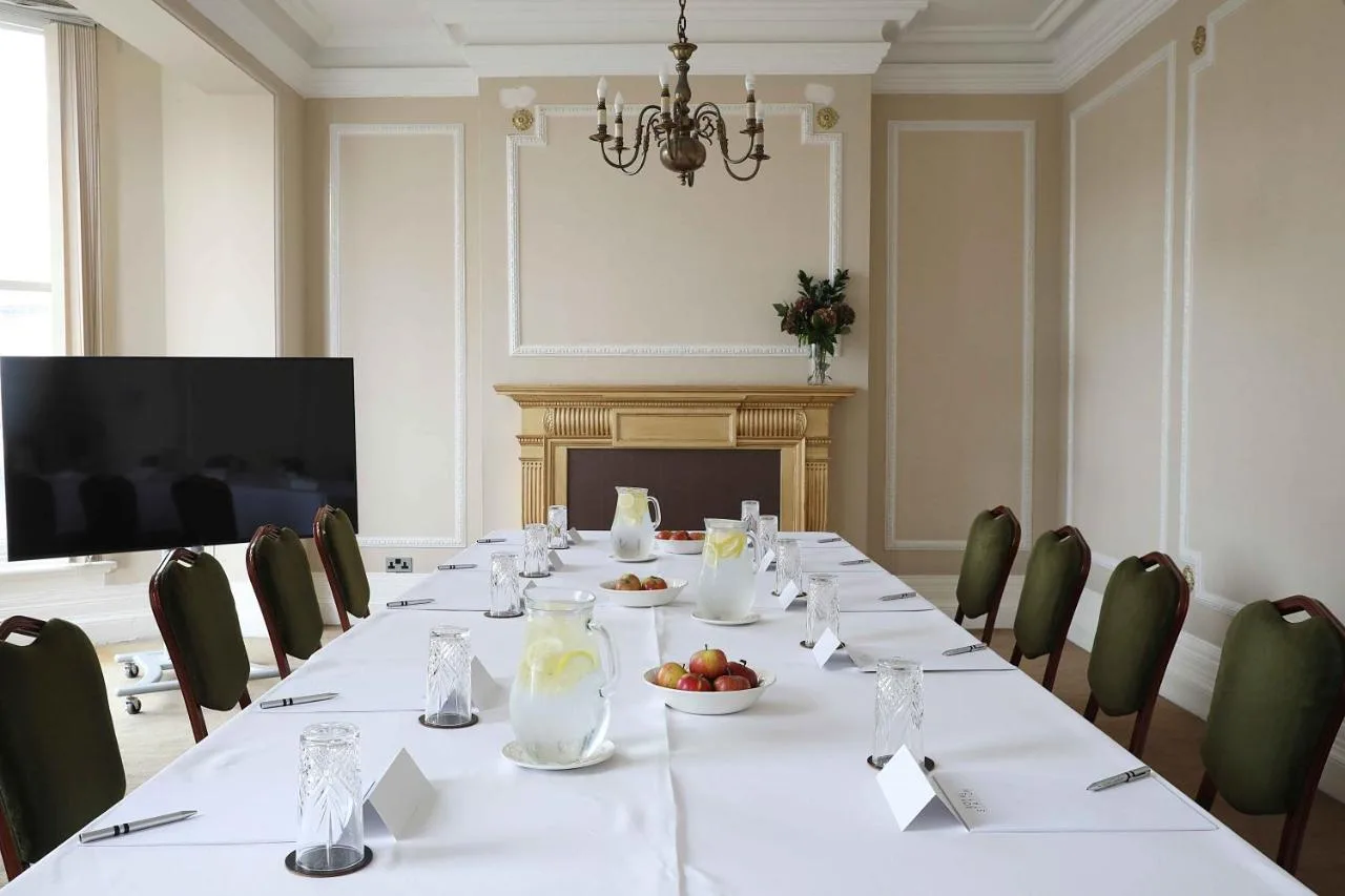 Conference room with long table and television at Royal Station Hotel, Newcastle upon Tyne